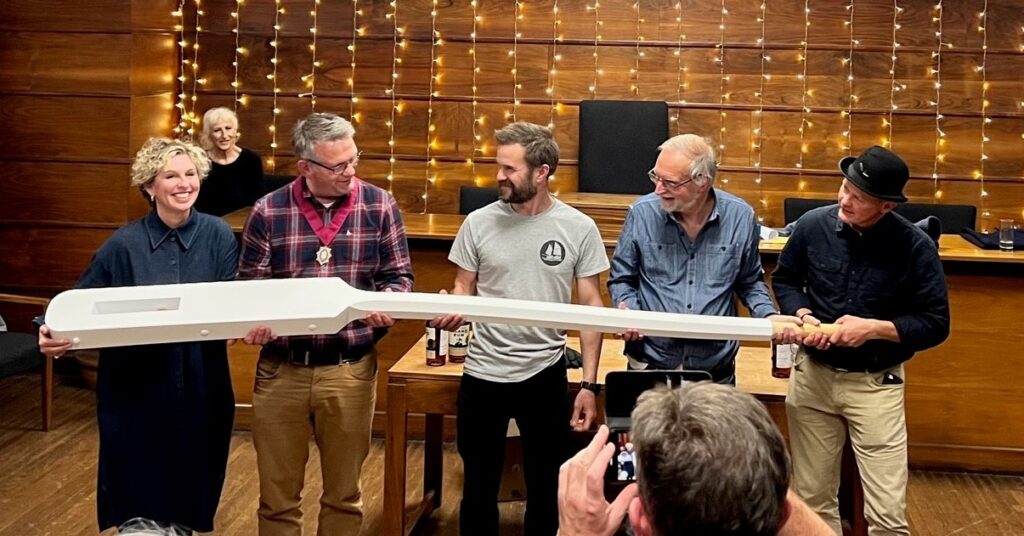 Presenting the tiller to the crew