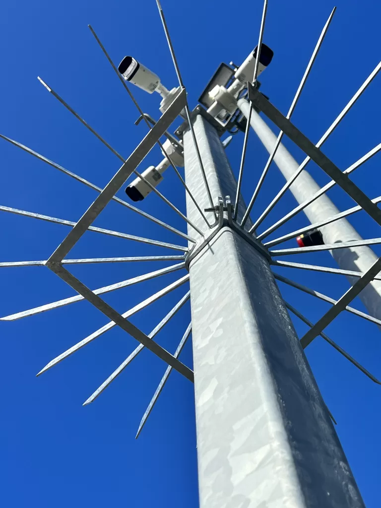 Metal pole with spikes and CCTV camera