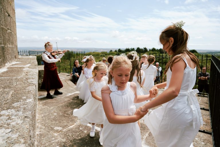 Girls in white dresses dancing